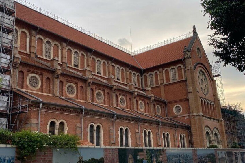 A large brick building with arched windows and a clock tower. 4