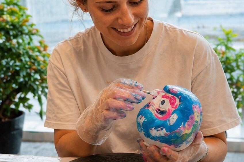 A person painting a globe with a cartoon character. 4