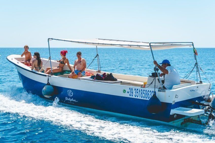 A boat with people on it, moving on the water. 2