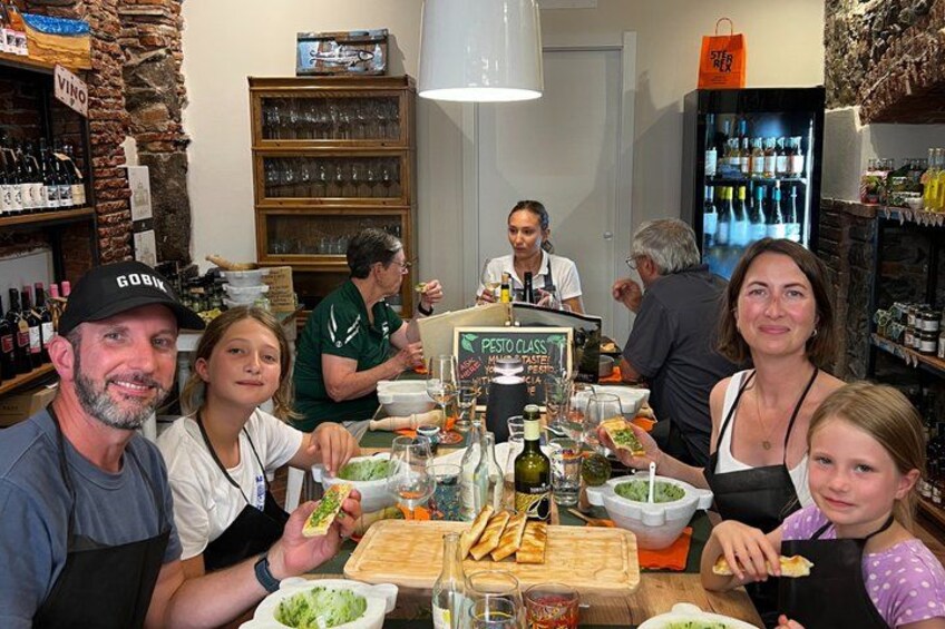 A group of people dining at a restaurant with a rustic interior, wooden shelves, and a menu board. 5