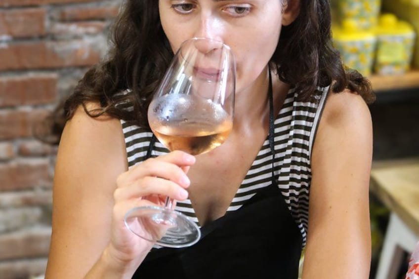 A person holding a wine glass. 4