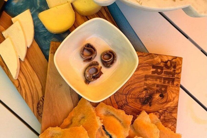 A wooden cutting board with a bowl of food, sliced apples, and a wooden sign with text. 3