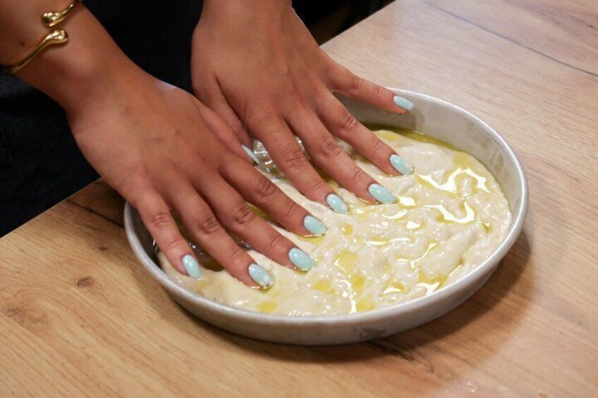 Hands mixing a creamy substance in a bowl. 1