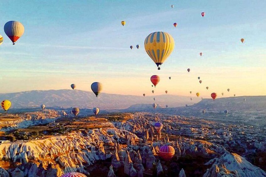 A landscape with numerous hot air balloons. 3