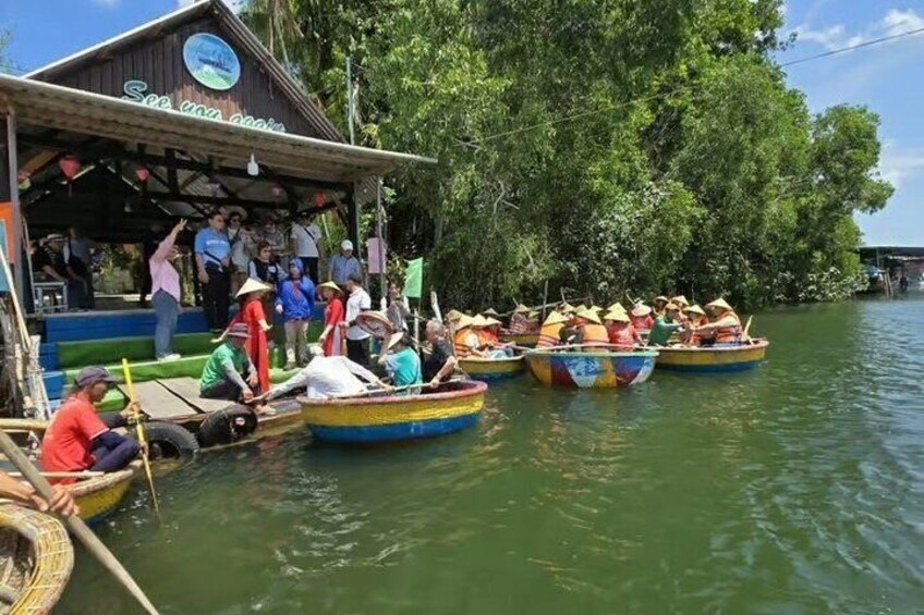 A group of colorful boats on a river, passengers wearing hats, and a dock with a sign. 1