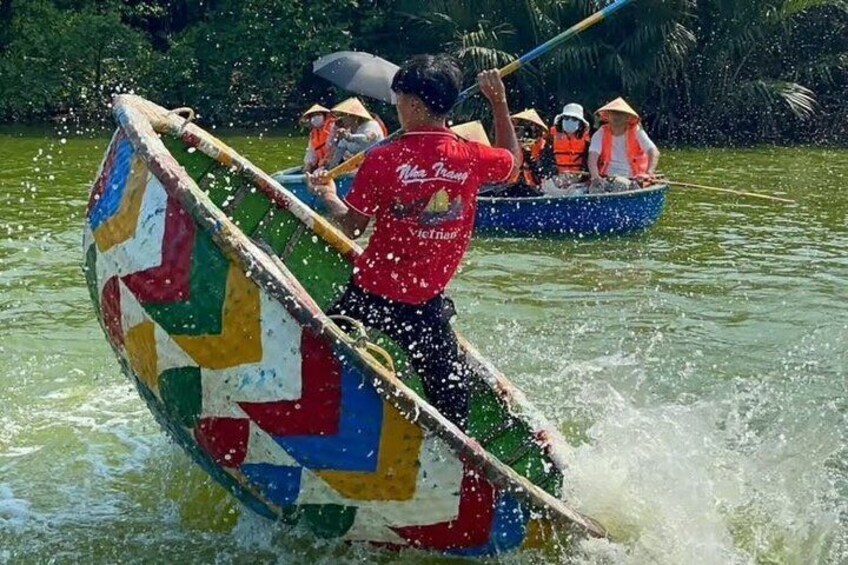 A person in a boat with a colorful flag, paddling through water. 4