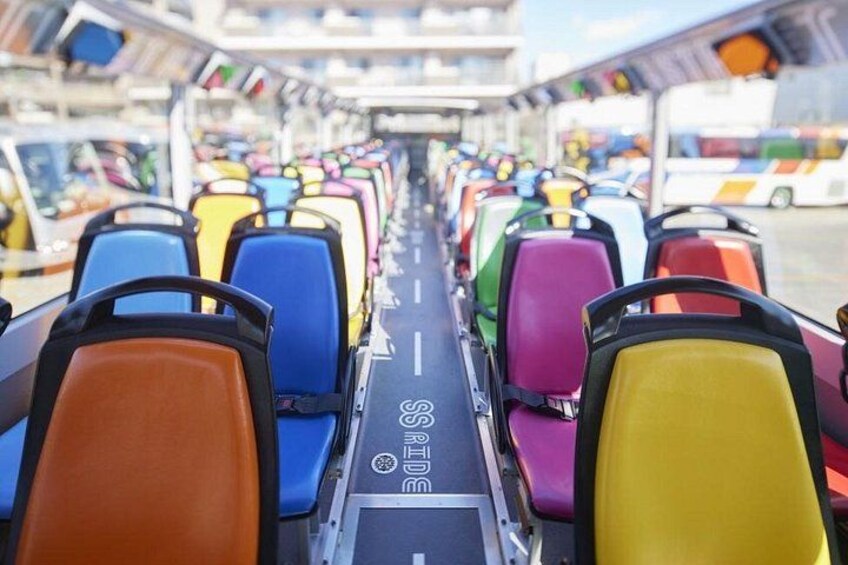 A row of colorful seats on a bus. 5