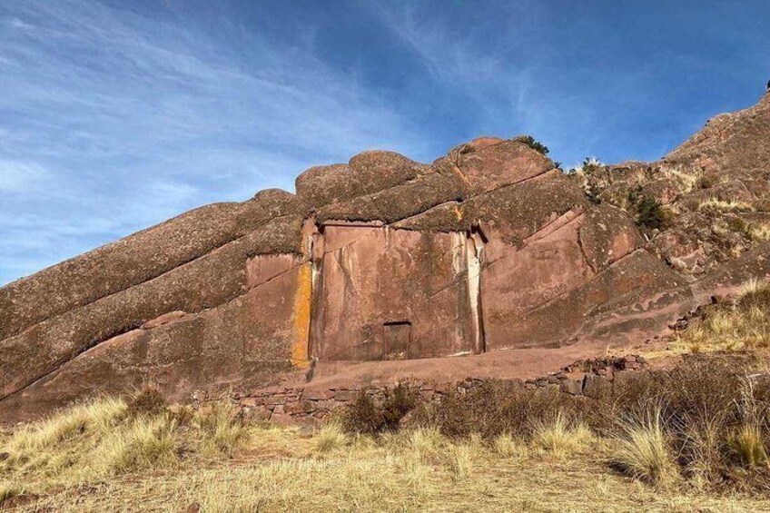 A large rock formation with a narrow passageway. 1
