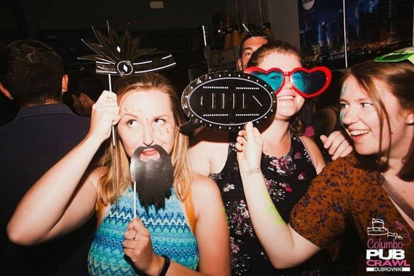 People holding props and wearing party hats. 2