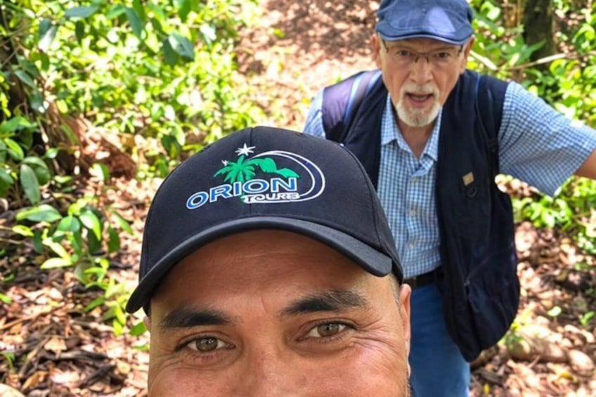 A person wearing a cap with a logo and a vest. 2