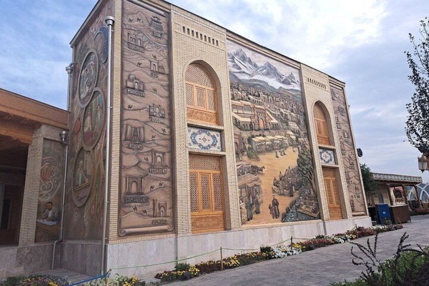 A building with a large mural depicting historical scenes and architectural elements. 5