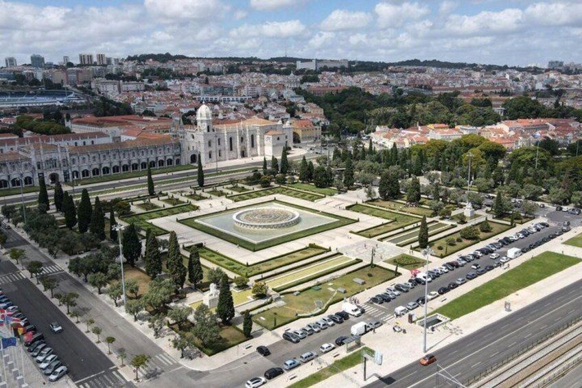 A cityscape with a large square, a prominent building with a dome, and a well-maintained garden. 5