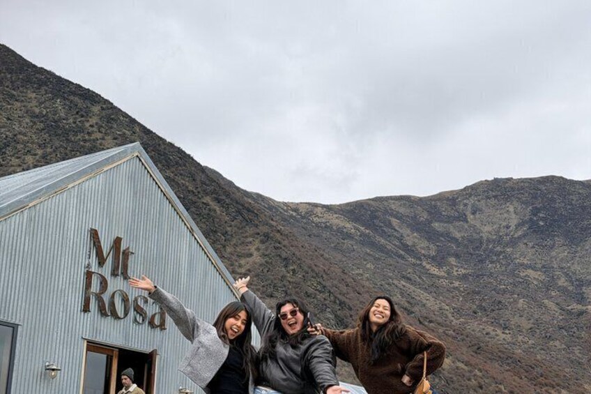 A group of people posing in front of a building with the sign 'Mt Rosa'. 1