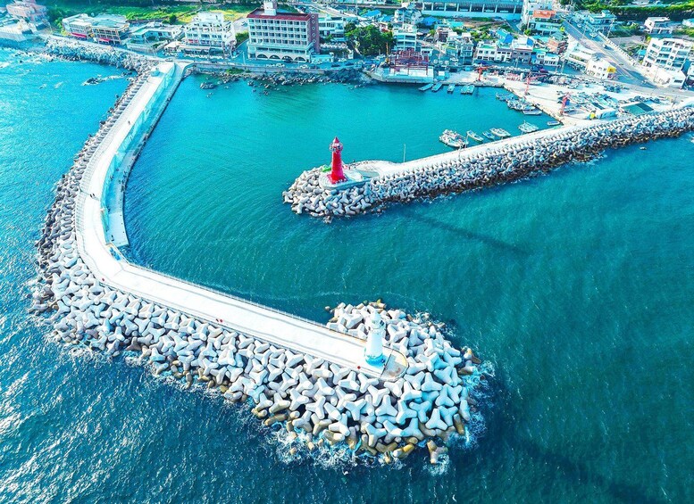 A coastal town with a lighthouse, a breakwater, and a marina. 4