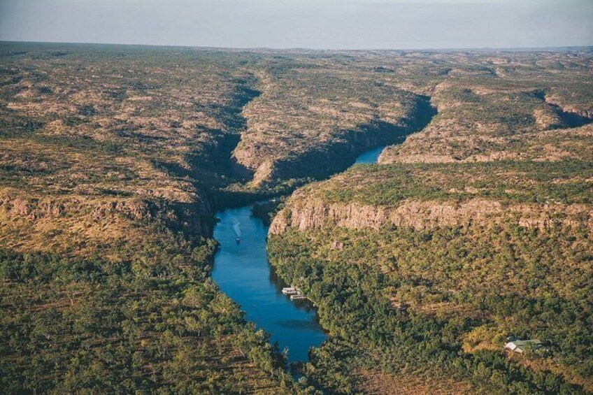 A river winding through a forested valley with steep cliffs. 3