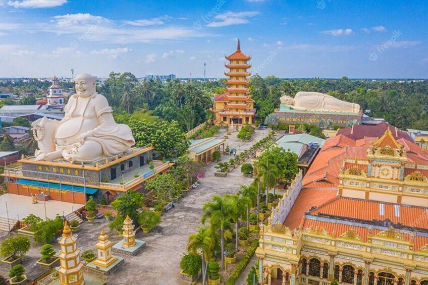 A large Buddha statue, a pagoda, and traditional architecture. 5