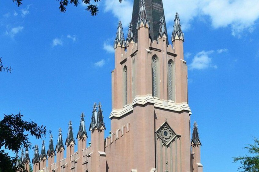 A church with a tall tower and multiple spires. 2