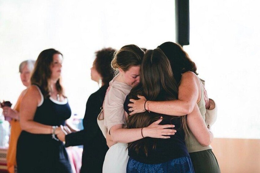 A group of people hugging each other. 2