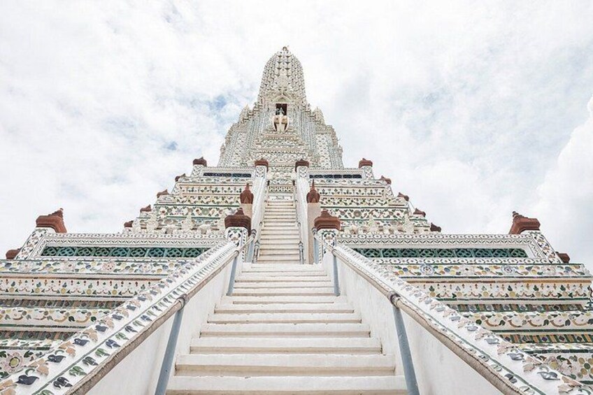 A temple with a large staircase leading to a spire. 5