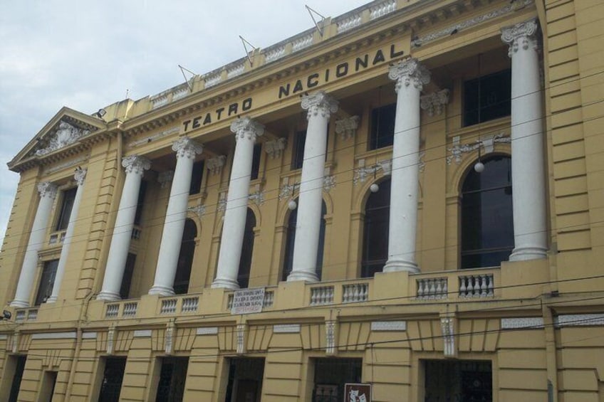 A yellow building with columns and the words 'TEATRO NACIONAL' on the facade. 4
