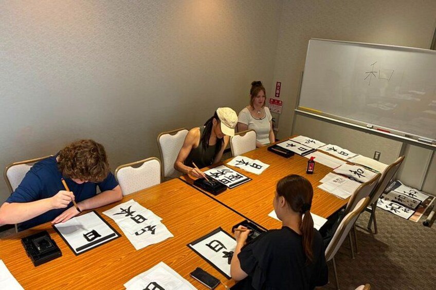 A meeting room with a wooden table, chairs, papers, and a whiteboard. 3