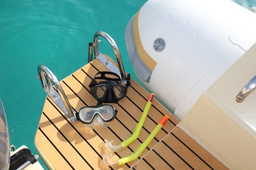 A boat deck with a diving mask, snorkel, and fins. 3