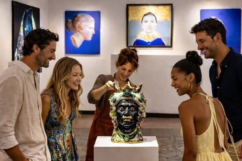 A group of people at an art exhibition, observing a sculpture. 2