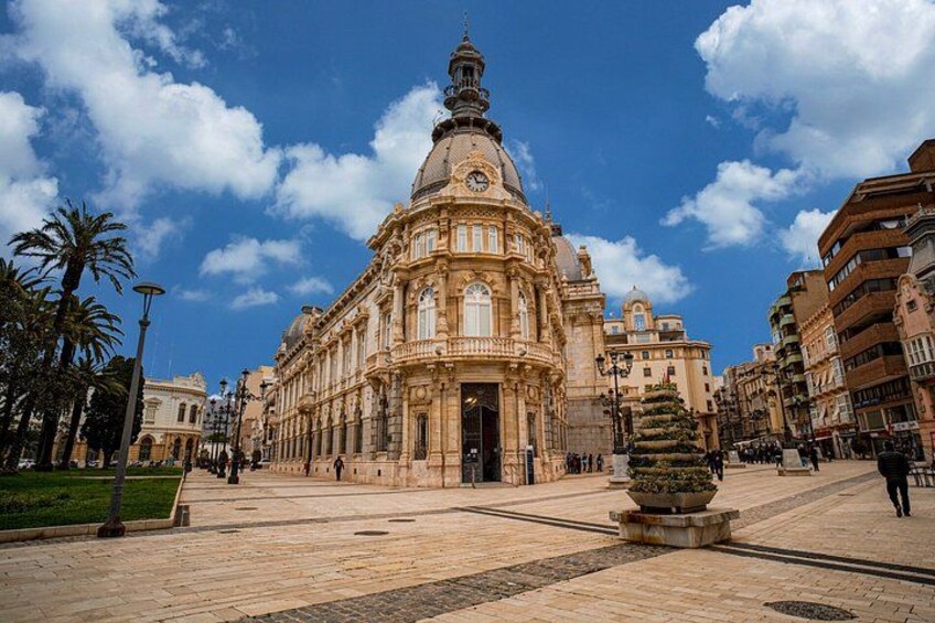 A historic building with a dome and columns, a fountain, and a clear blue sky. 4