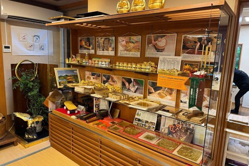 A display case with various items, including framed pictures and small boxes. 2