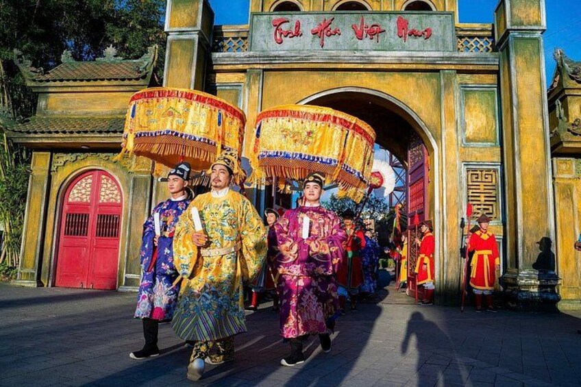 A traditional Chinese opera performance with performers in elaborate costumes and a large ornate gate in the background. 5
