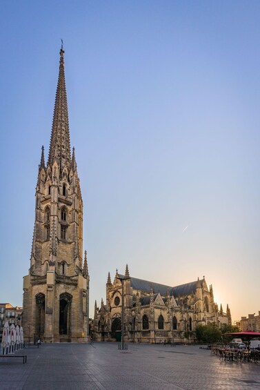 A cathedral with a tall spire and a large entrance. 3