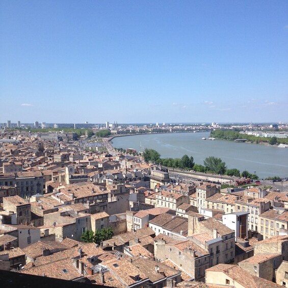 A cityscape with a river, historic buildings, and a bridge. 2