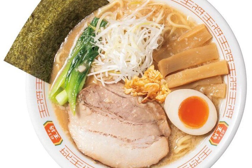 A bowl of ramen with noodles, pork, boiled egg, seaweed, and vegetables. 4