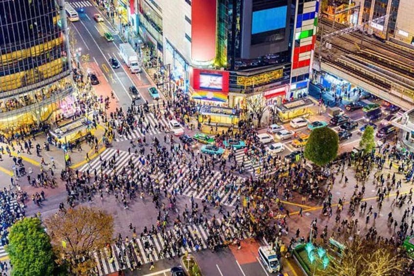 A busy urban intersection with pedestrians and vehicles. 3