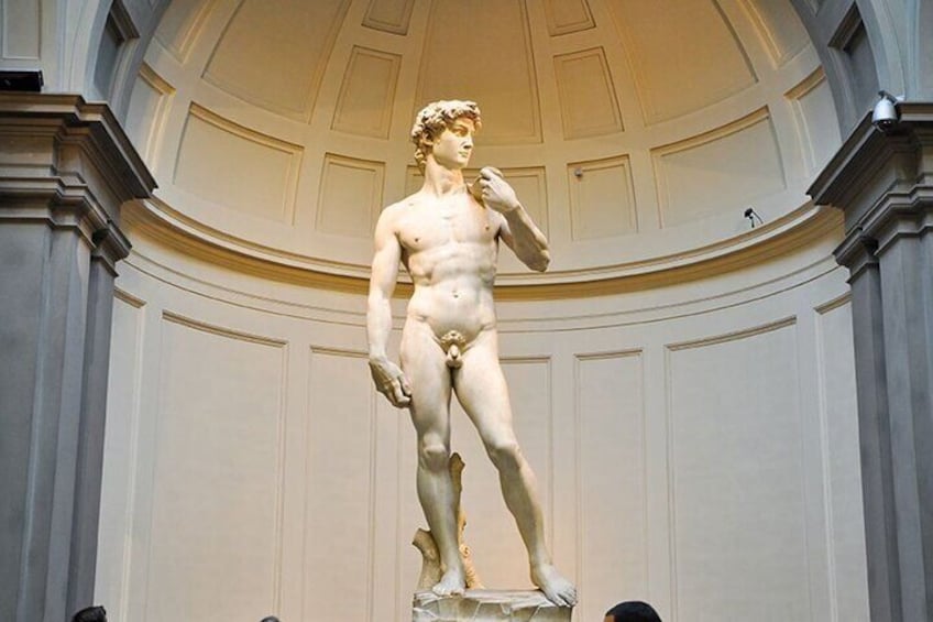 A classical statue in a grand hall with high ceilings and ornate moldings. 3
