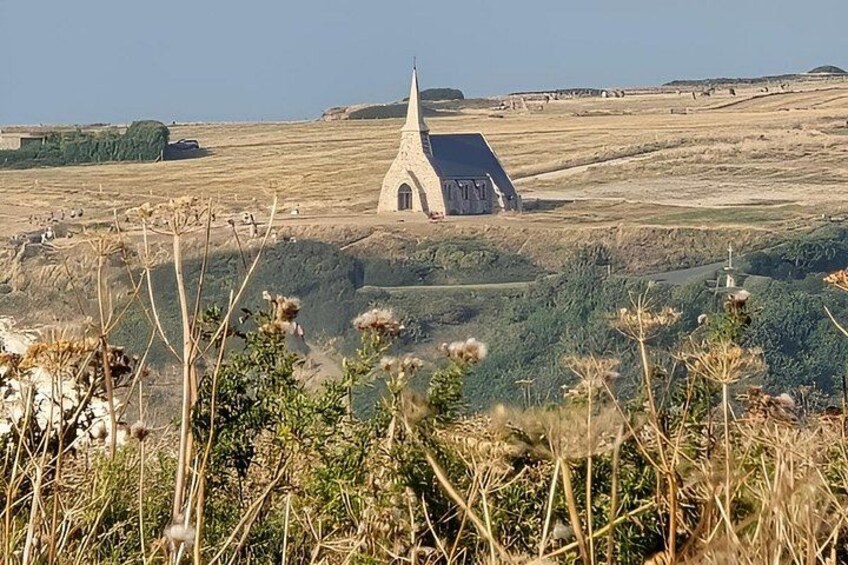 A church with a pointed steeple in a rural landscape. 3