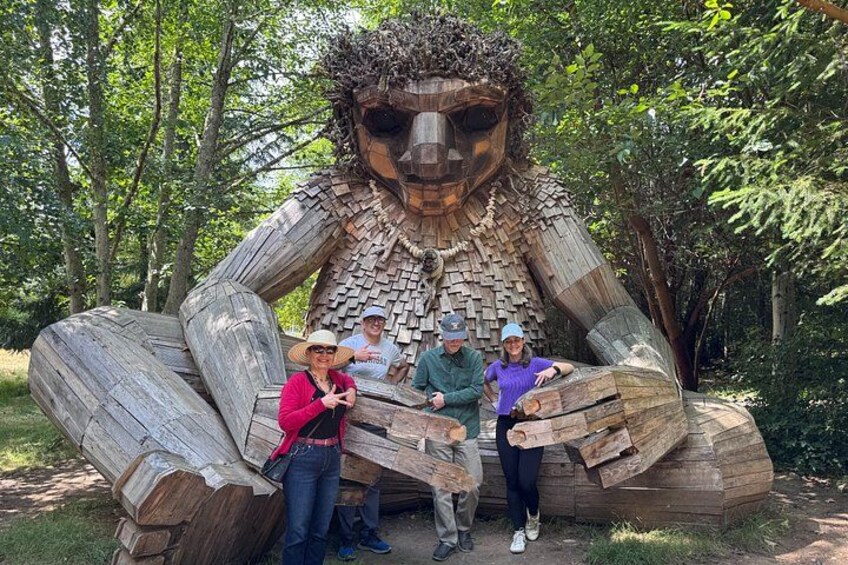 A large wooden sculpture of a face in a forest. 2