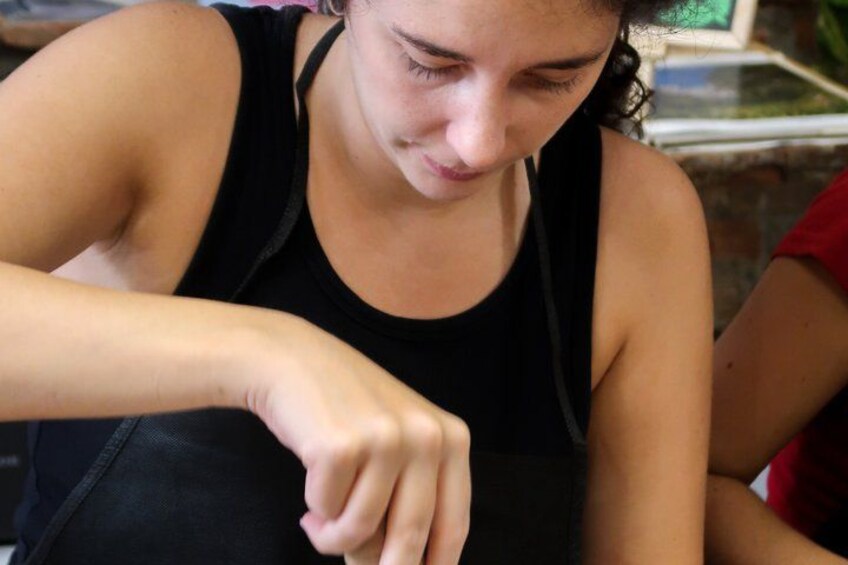 A person wearing a black sleeveless top. 3