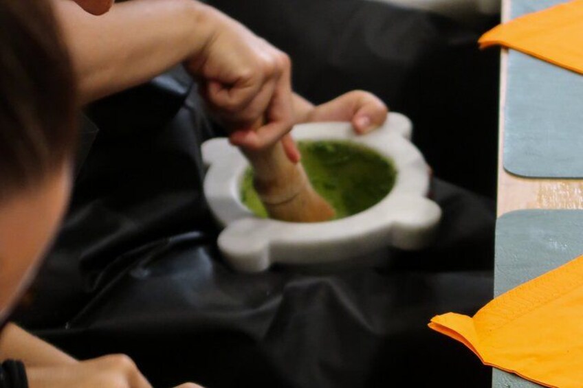 A person using a mortar and pestle. 4