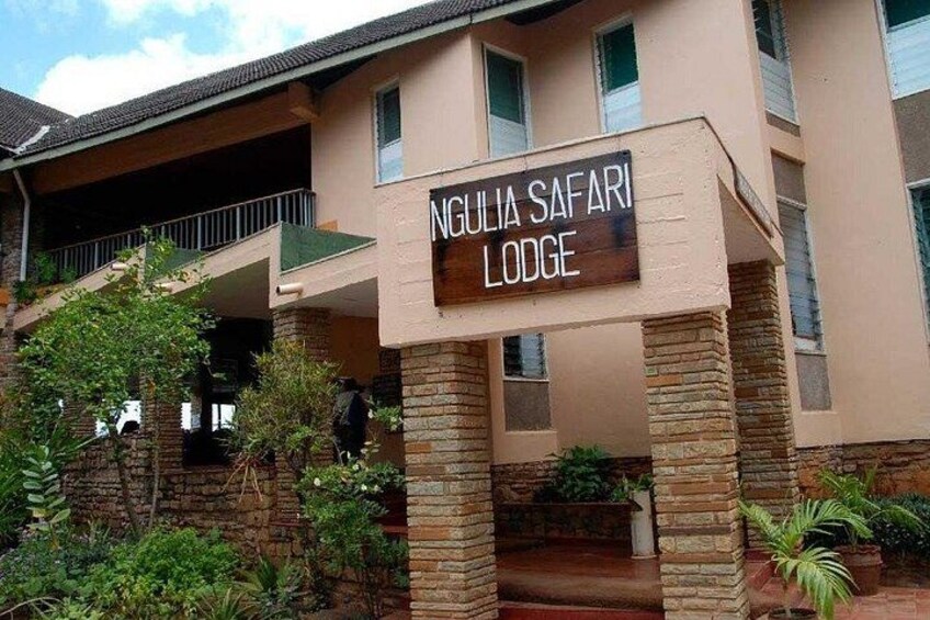 A building with a sign reading 'Ngulia Safari Lodge.' 5