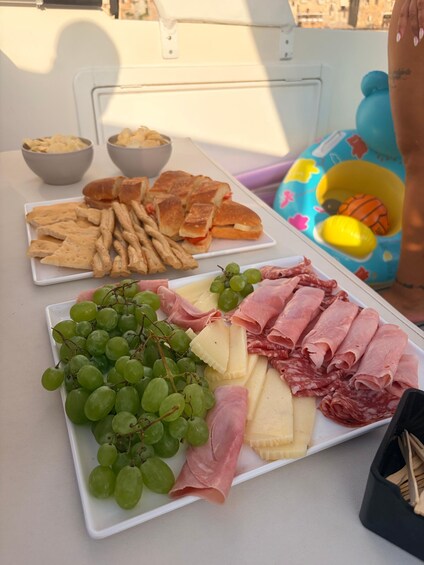 A table with various food items including bread, crackers, cheese, and meats. 2