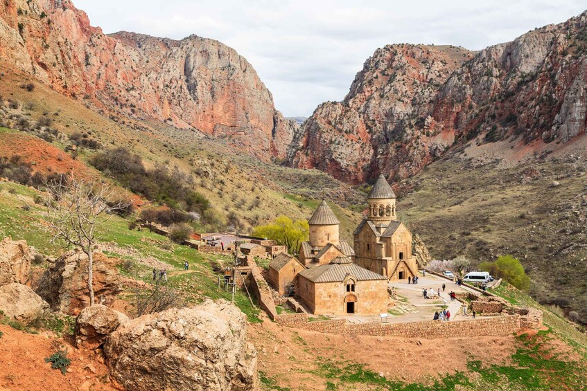 A historic church surrounded by rugged mountains. 1