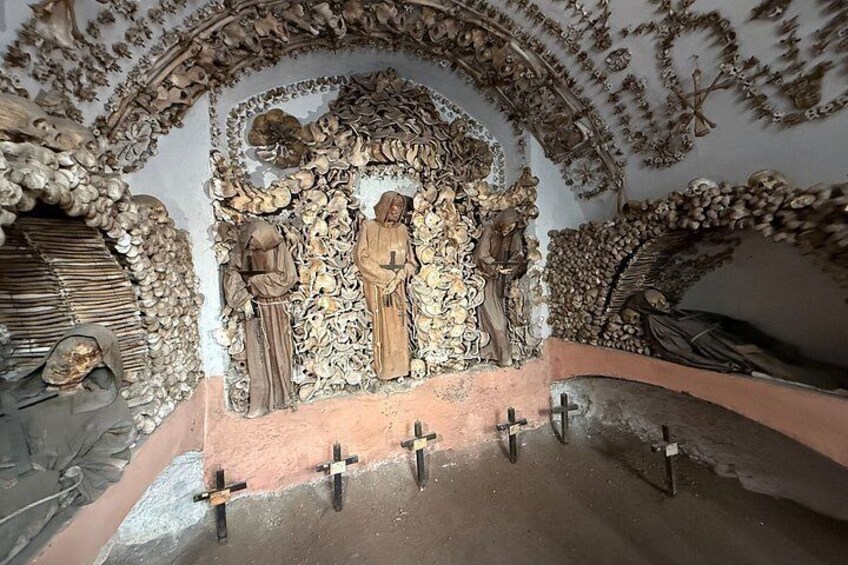 A detailed stone carving with religious figures, crosses, and intricate designs. 2