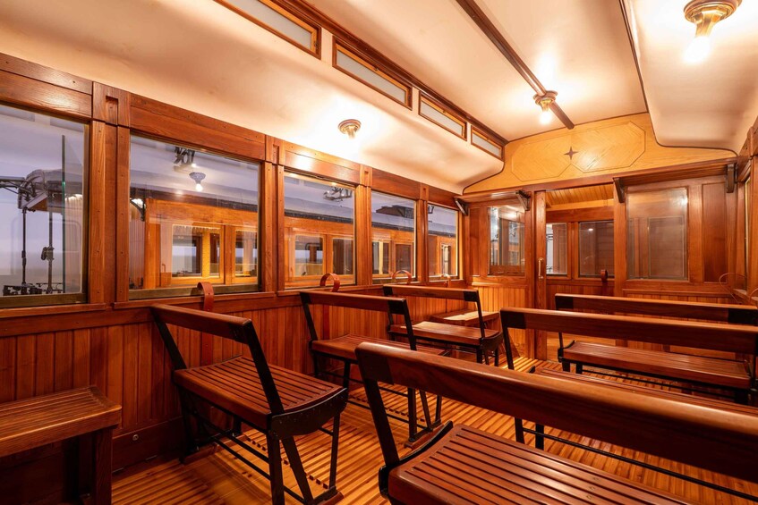 A wooden interior with benches and windows. 3