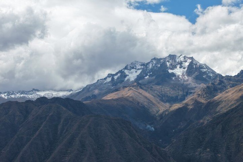 A mountain range with snow-capped peaks and a valley. 3