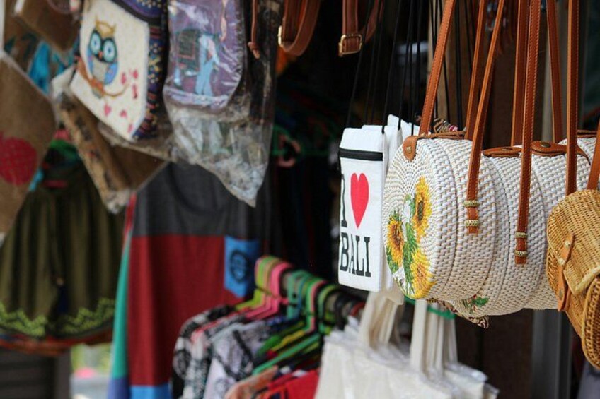 A variety of bags hanging, including a white bag with 'I ♥ BALI' printed on it. 2
