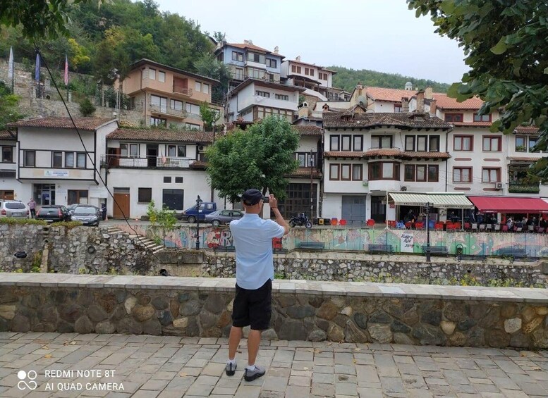 A person taking a photo with a Redmi Note 8T AI Quad Camera. 3