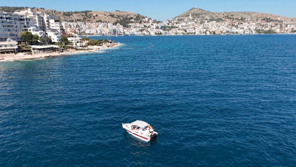 A coastal cityscape with a boat on the water. 3