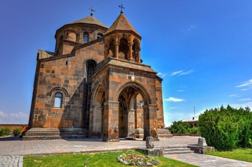 A stone church with a central dome and arched entrance. 2