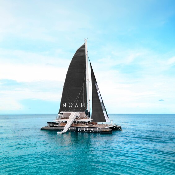 A sailboat named 'NOAH' on calm blue waters. 1
